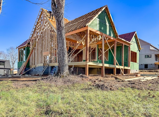 back of property featuring metal roof and an outdoor structure