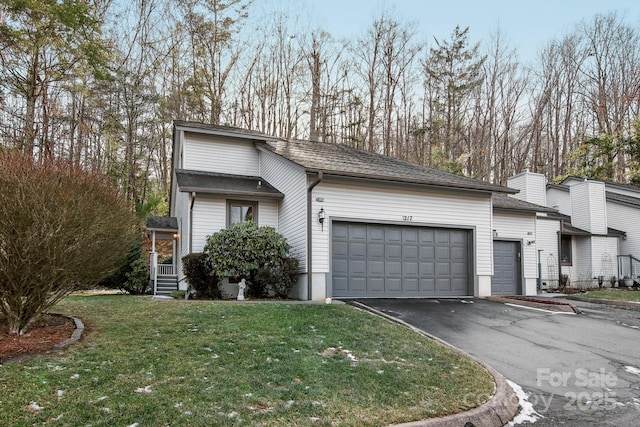 view of property exterior with an attached garage, a yard, driveway, and roof with shingles