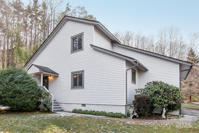 view of home's exterior with crawl space and a yard