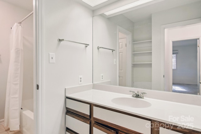 full bath featuring shower / bath combo with shower curtain and vanity