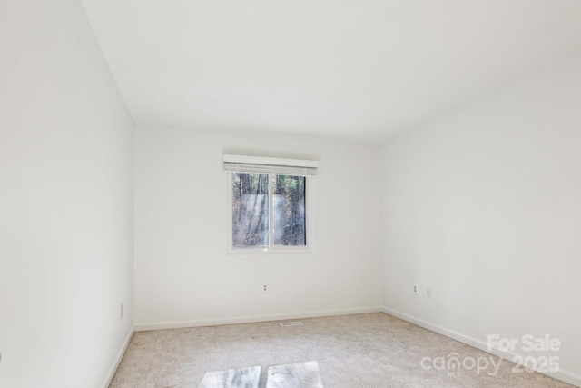 empty room featuring baseboards and carpet floors