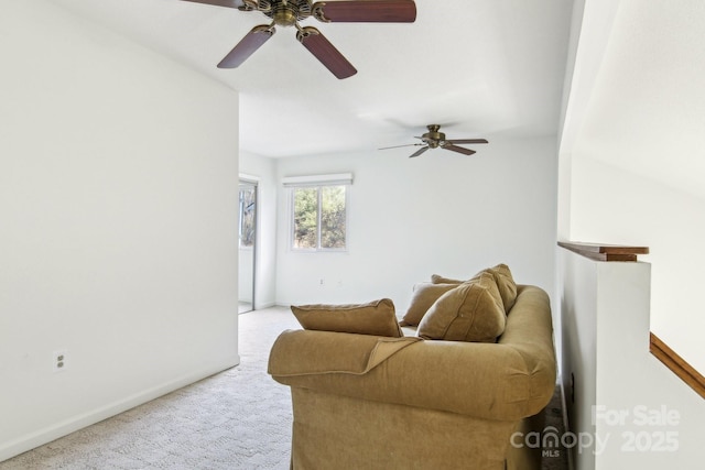 carpeted living area with baseboards