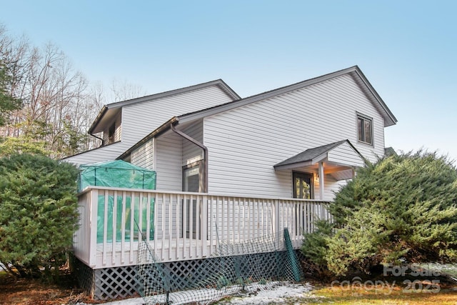 view of property exterior featuring a wooden deck