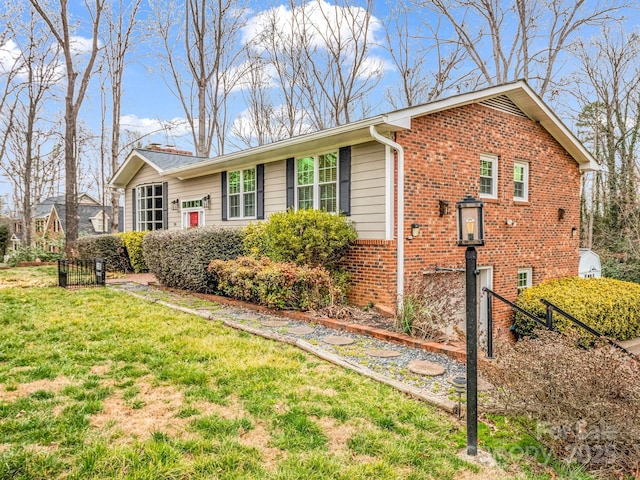 view of front of property with brick siding and a front lawn