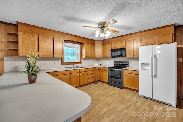 6285 NC-16 Hwy N, Taylorsville, NC 28681 - kitchen featuring white fridge with ice dispenser, black microwave, stainless steel electric range oven, a sink, and light wood-style flooring