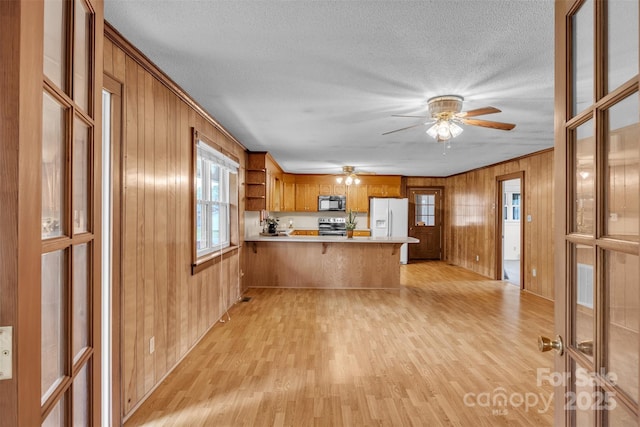 6285 NC-16 Hwy N, Taylorsville, NC 28681 - kitchen with stainless steel electric range oven, black microwave, light wood-style flooring, a peninsula, and light countertops