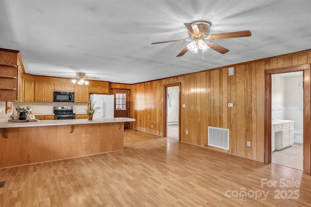 6285 NC-16 Hwy N, Taylorsville, NC 28681 - kitchen with black microwave, white refrigerator with ice dispenser, electric stove, a ceiling fan, and light countertops
