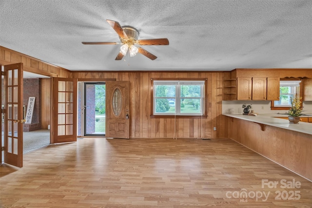 6285 NC-16 Hwy N, Taylorsville, NC 28681 - kitchen featuring french doors, light wood finished floors, open shelves, wooden walls, and light countertops