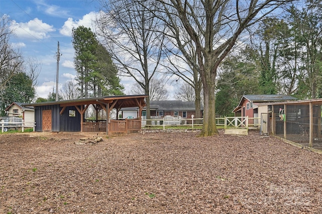 view of yard with an outdoor structure and fence