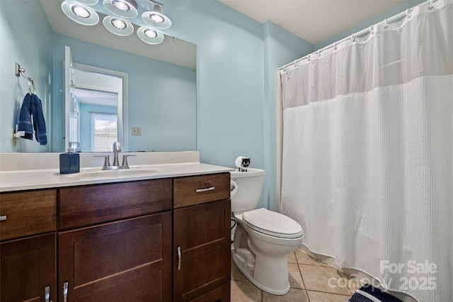 full bathroom with toilet, curtained shower, vanity, and tile patterned floors