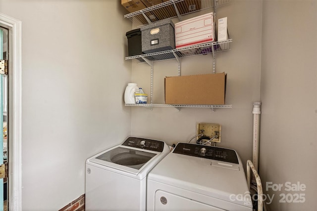 clothes washing area with washer and dryer and laundry area