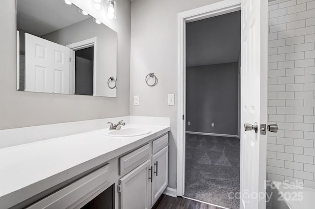 bathroom featuring baseboards and vanity