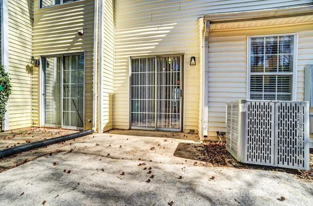 doorway to property with a patio area and central AC unit