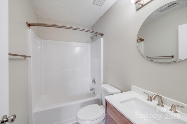 bathroom with vanity, toilet, visible vents, and a textured ceiling