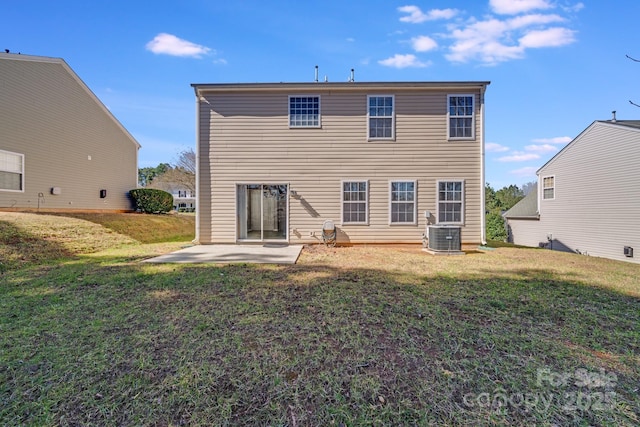 back of property with a patio, central air condition unit, and a yard