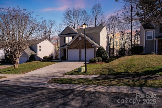 property exterior at dusk with stone siding, a lawn, and concrete driveway