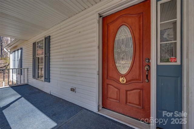 view of exterior entry with a porch