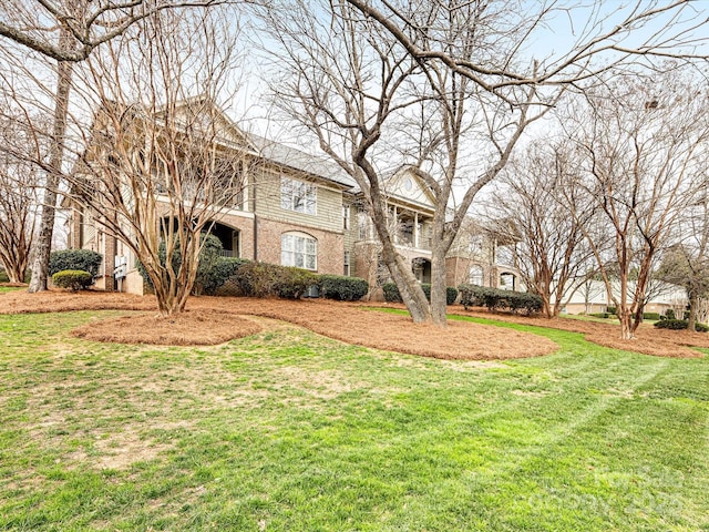 view of front of property with brick siding and a front yard