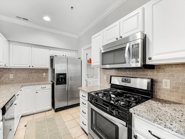 kitchen featuring appliances with stainless steel finishes, white cabinets, and crown molding