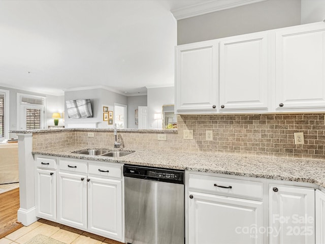 kitchen with light stone counters, decorative backsplash, stainless steel dishwasher, ornamental molding, and a sink