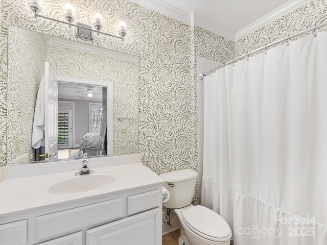 bathroom with toilet, wallpapered walls, connected bathroom, and crown molding