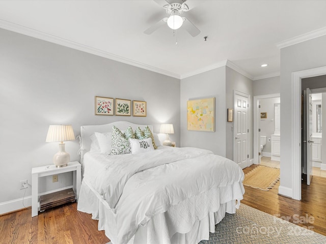 bedroom featuring ornamental molding, wood finished floors, and baseboards