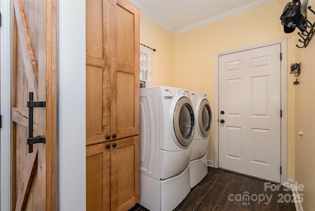 laundry room featuring baseboards, wood finish floors, cabinet space, ornamental molding, and washer and dryer
