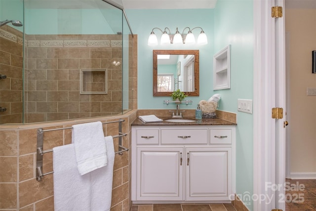 full bathroom with vanity and tiled shower