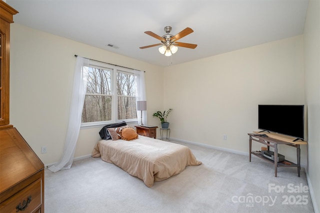 bedroom with visible vents, light colored carpet, a ceiling fan, and baseboards