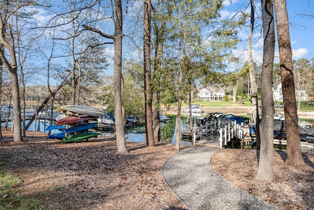 exterior space featuring a dock and a water view
