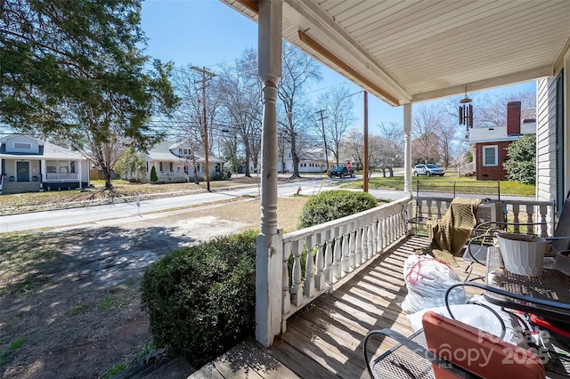 deck featuring a porch and a residential view