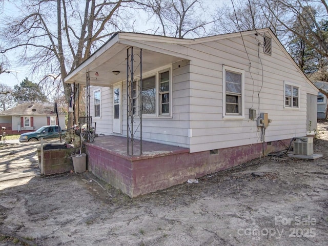 view of front of house featuring covered porch, crawl space, and central air condition unit