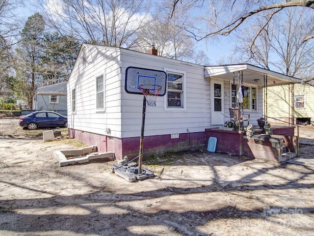 view of front of property featuring a porch and a chimney