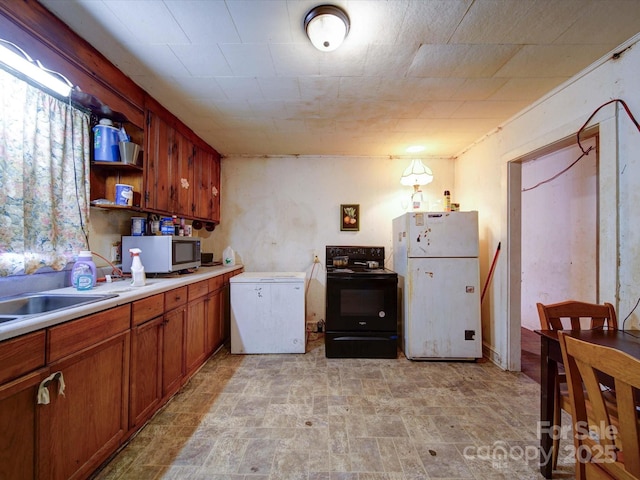 kitchen with white appliances, brown cabinets, light countertops, open shelves, and a sink