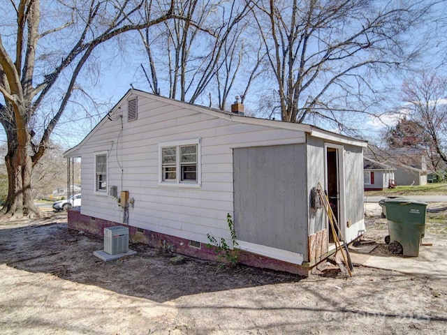 view of side of property with crawl space and a chimney