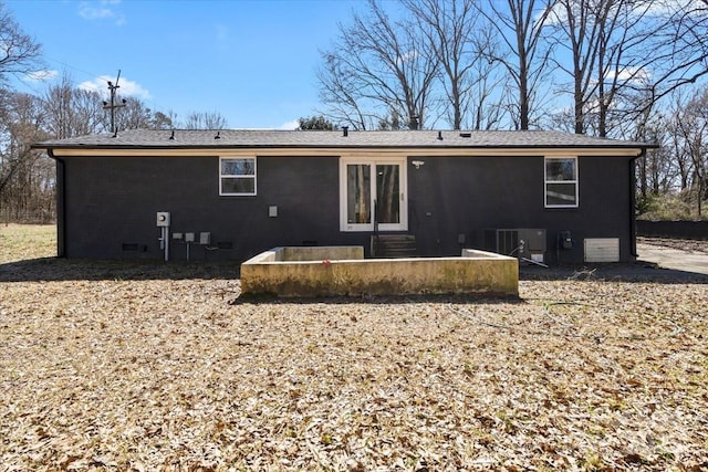 back of property featuring entry steps, crawl space, and central air condition unit