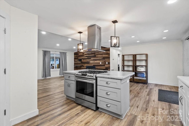 kitchen with light countertops, gas stove, gray cabinets, and island range hood