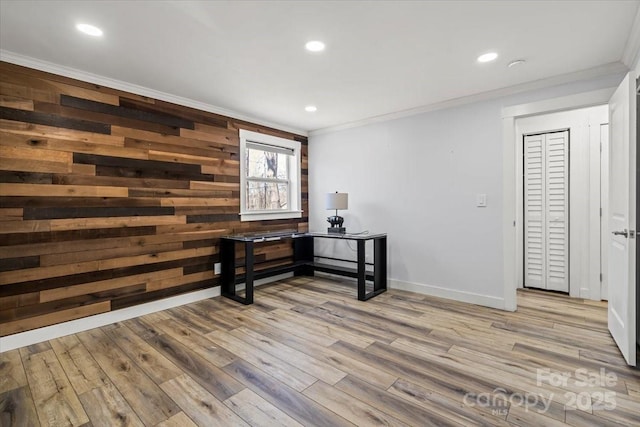 interior space featuring recessed lighting, wood walls, wood finished floors, baseboards, and ornamental molding