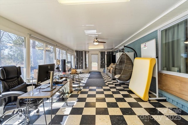 sunroom / solarium with a ceiling fan