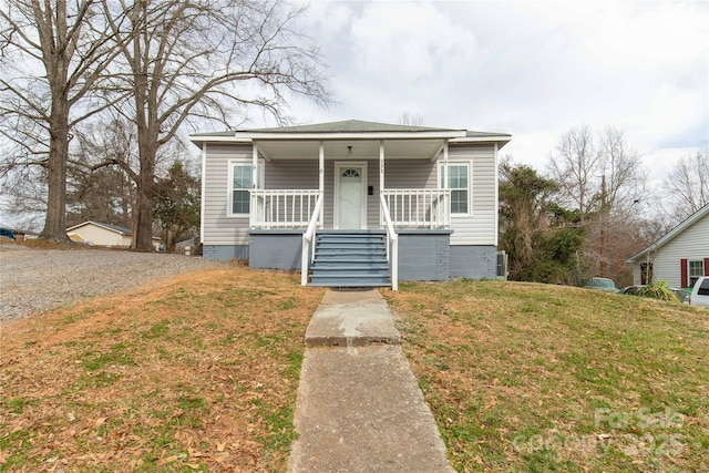 bungalow with crawl space, stairs, a porch, and a front yard