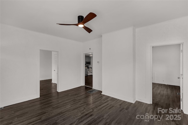 empty room with ceiling fan, crown molding, wood finished floors, and baseboards