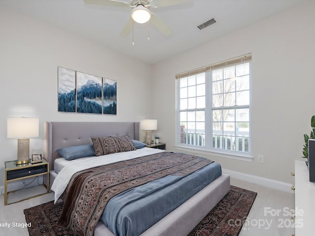 bedroom with baseboards, visible vents, ceiling fan, and carpet flooring