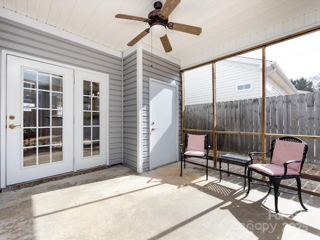 sunroom with wood ceiling and a ceiling fan