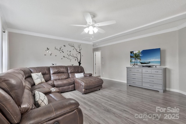 living room with ceiling fan, wood finished floors, and crown molding