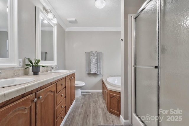 full bathroom with a garden tub, a sink, and a shower with shower door