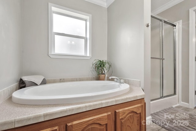 full bath featuring a stall shower, a garden tub, and crown molding