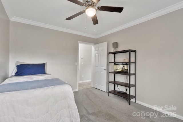 carpeted bedroom featuring baseboards, a ceiling fan, and ornamental molding