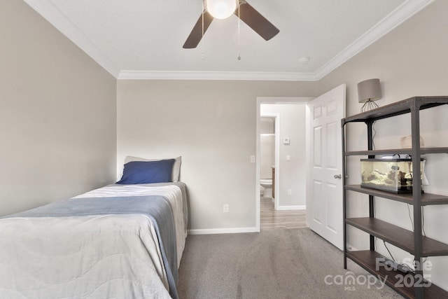 bedroom featuring baseboards, carpet floors, a ceiling fan, and crown molding