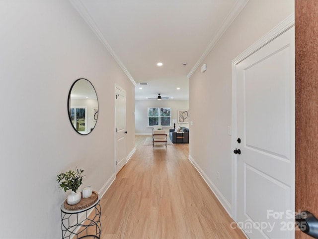 hall featuring visible vents, ornamental molding, baseboards, recessed lighting, and light wood-style flooring