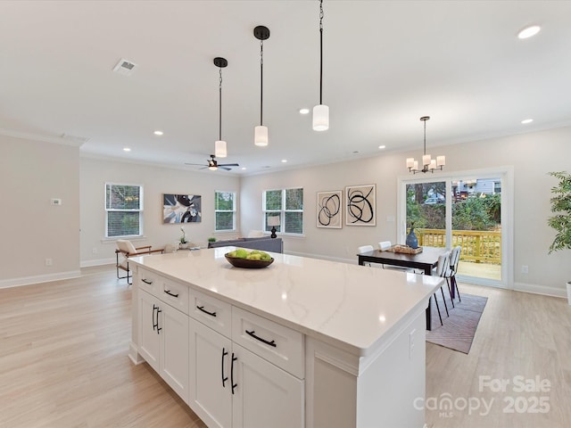 kitchen featuring a kitchen island, recessed lighting, a wealth of natural light, and light wood-style flooring